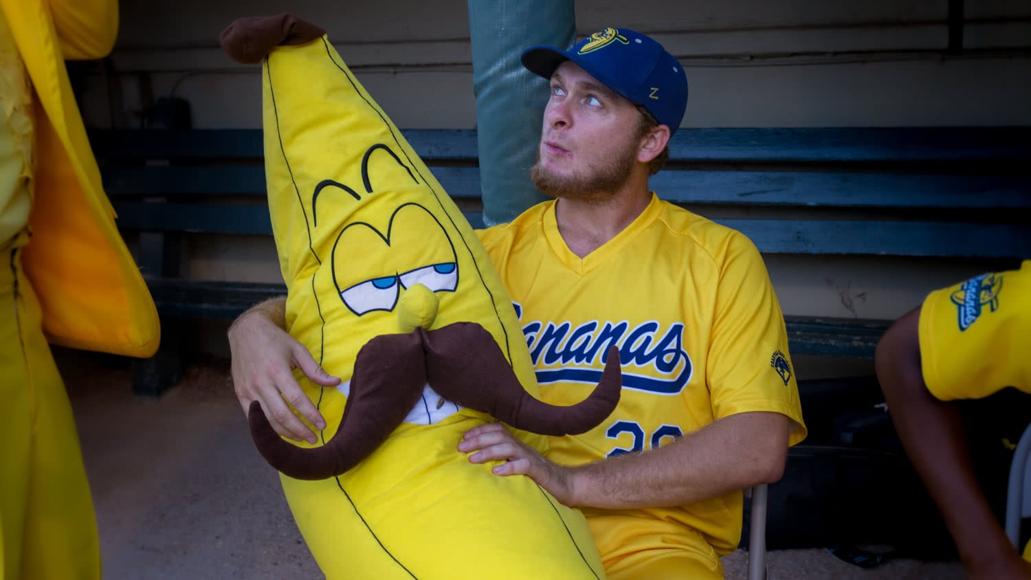 Stuffed Banana with Handlebar Mustache Checks Out Baseball Player